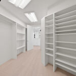 Bright, spacious walk-in closet with ample shelving and natural light.