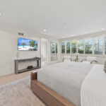Bright, modern bedroom with large windows and minimalist decor.