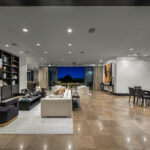 Modern open living space with sleek furniture and city view.