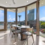 Modern dining area with large windows and scenic views.