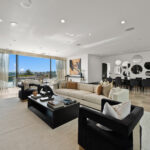 Modern living room with large windows and stylish furniture.