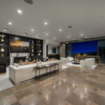 Modern open-concept kitchen and living area with sleek design and city view.